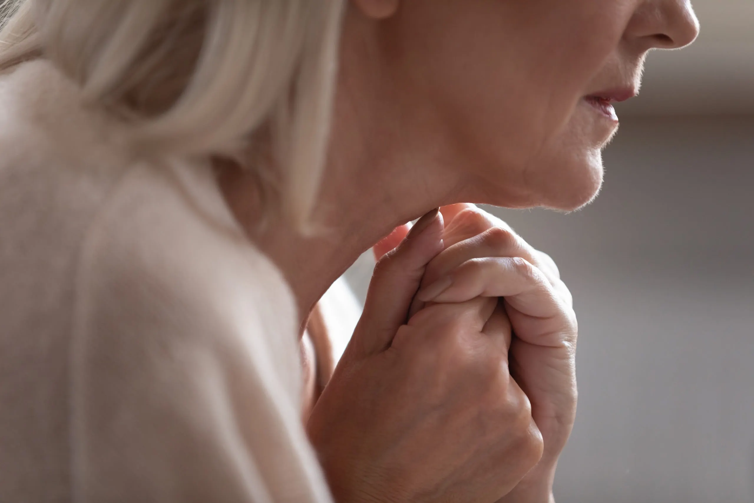 Close,up,side,view,older,worrying,retired,woman,joined,hands
